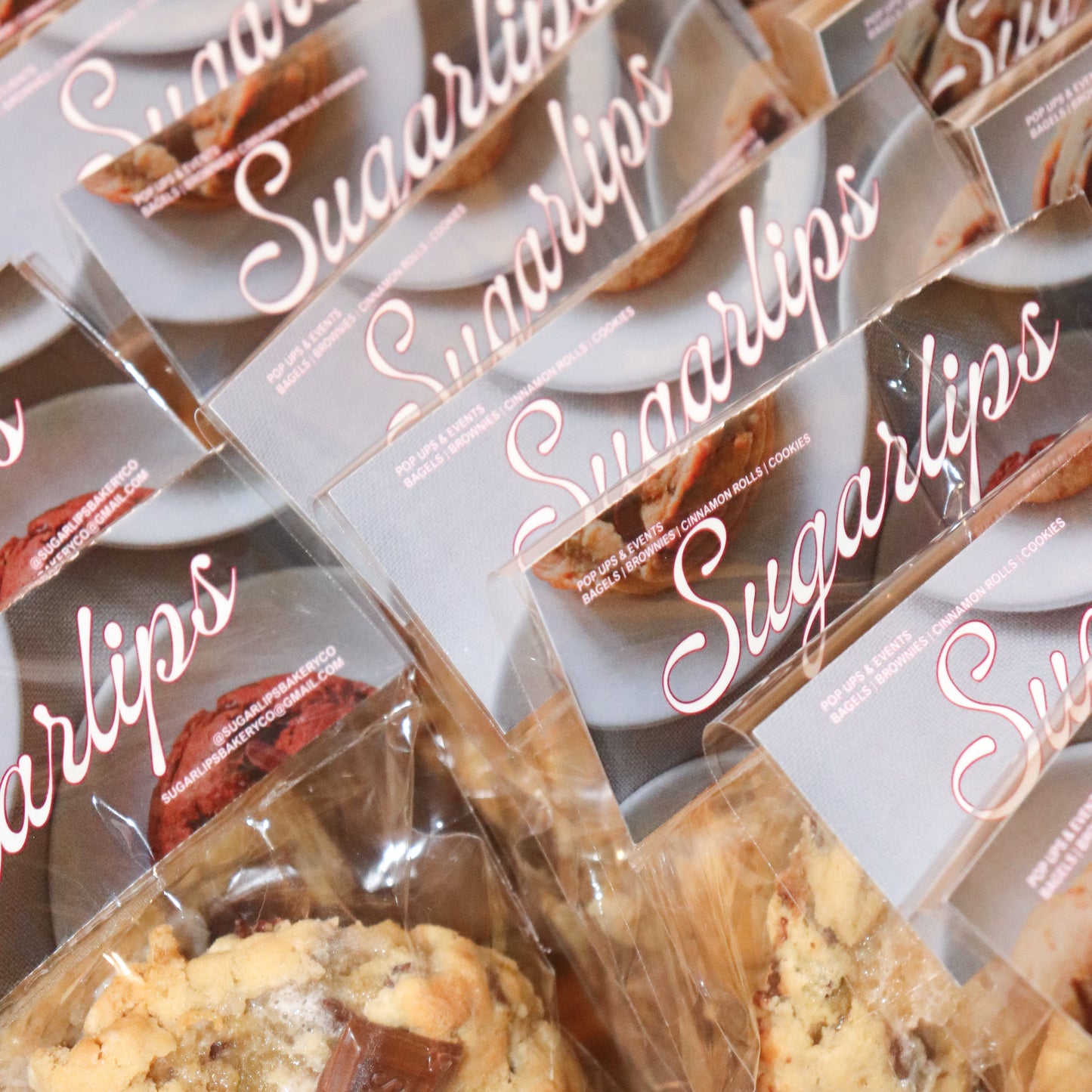 Multiple packages of Sugarlips cookies with clear plastic wrapping.