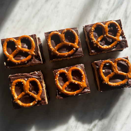 Chocolate bars with pretzel pieces on a marble surface