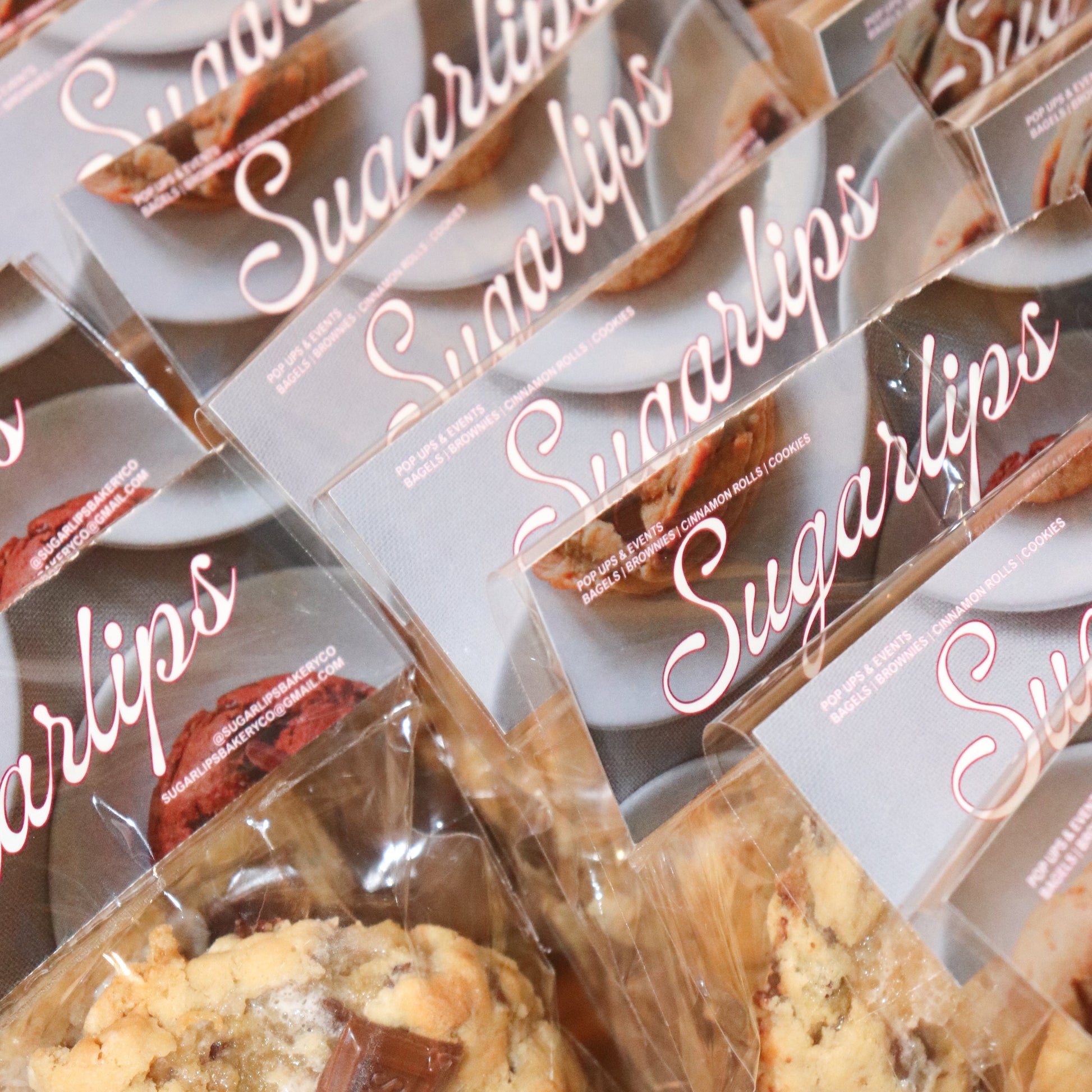 Multiple packages of Sugarlips cookies with clear plastic wrapping.