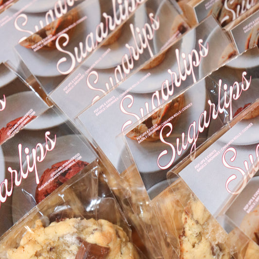 Multiple packages of Sugarlips cookies with clear plastic wrapping.